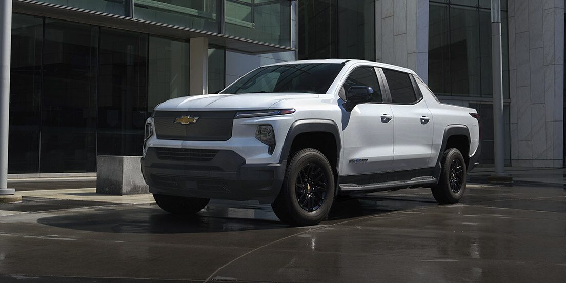 A GM Envolve EV parked outside a modern building.