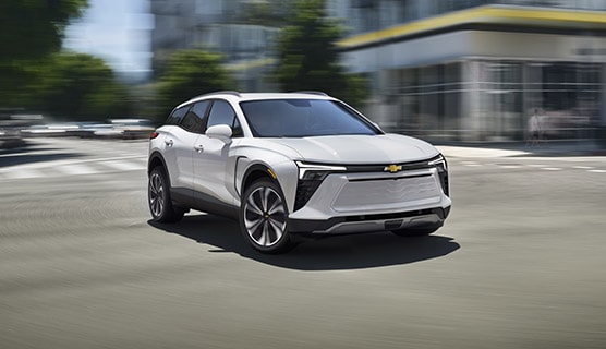 A GM Envolve vehicle driving alone in the city.