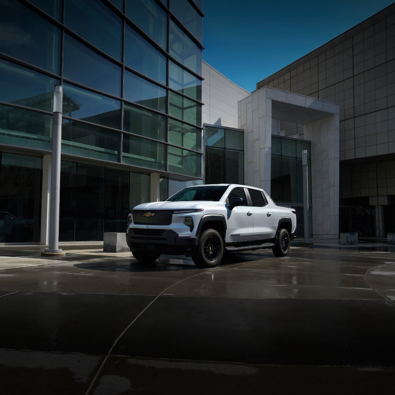 A GM Envolve vehicle parked beside a building.