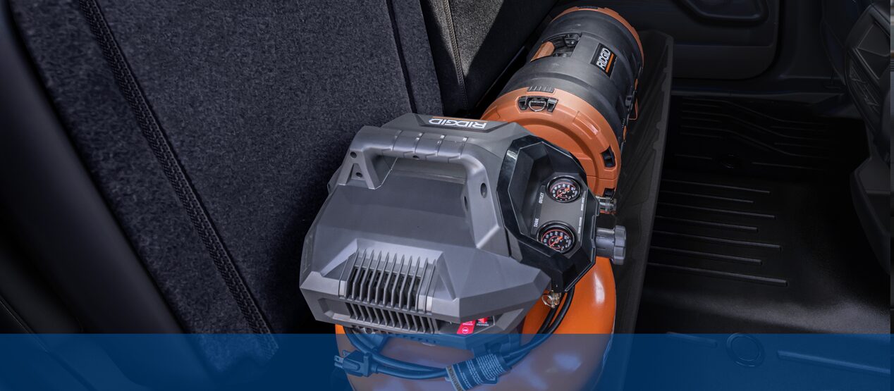 Loaded storage compartment under the second-row seats of the Chevrolet Silverado EV WT.