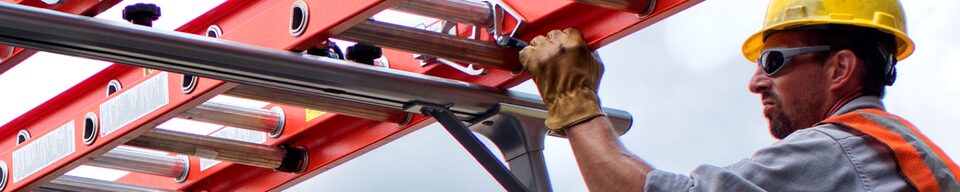 A construction worker attaching a utility rack on a GM Fleet vehicle.