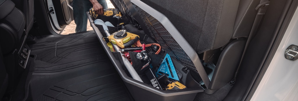 Close-up view of the underseat storage organizer of a GM Fleet vehicle.