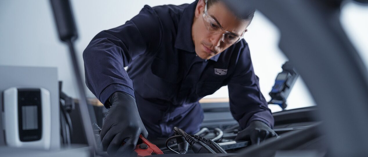 A GM Fleet personnel making repairs to a vehicle.