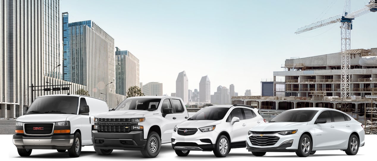 Lineup of GM Small Fleet vehicles parked on a city background.