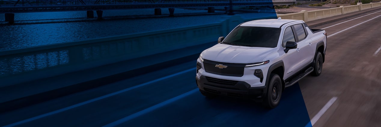 A GM Envolve vehicle driving alone on a bridge.