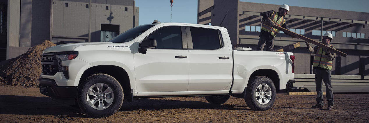 A GM Envolve work truck parked at a construction site.