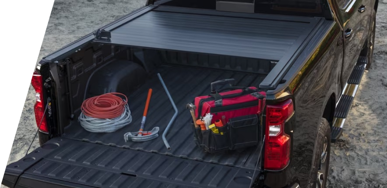 Vue arrière du coffre d'un camion GM Envolve 2024 avec de l'équipement dessus.