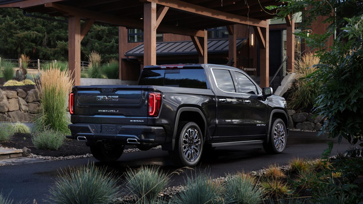 Back-side view of the 2024 Sierra 1500 parked under a roof.