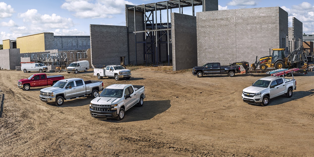 Multiple GM Commercial Vehicles parked at a construction site.