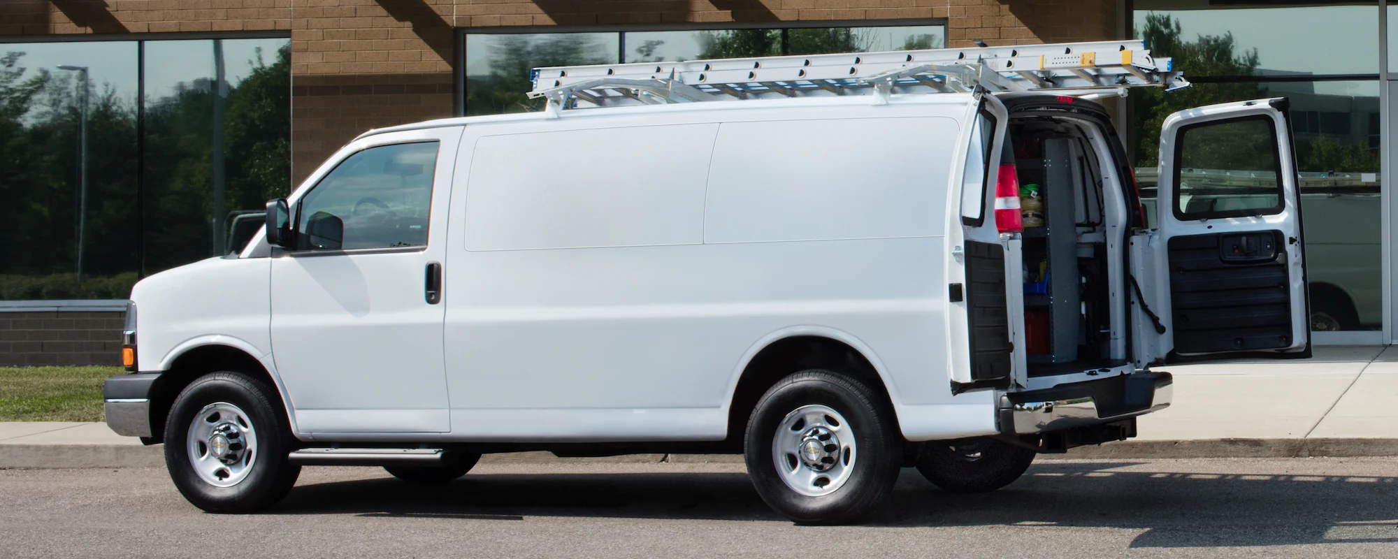 2024 GM Envolve Chevrolet Express Cargo Van with its rear trunk open.