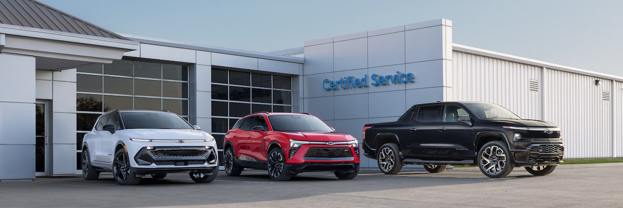 Three GM Envolve Fleet vehicles parked outside a building.