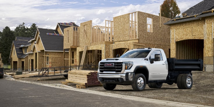 Chevrolet Silverado 3500 HD Chassis Cab with a Dump Truck upfit application on a job site.
