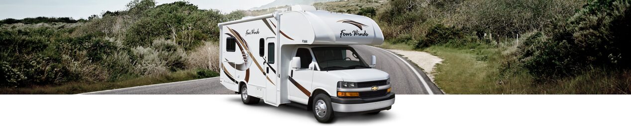 A GM Fleet RV with Cutaway Upfit Applications on a hillside road.