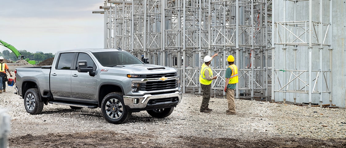 Side view of a GM Envolve truck parked at a construction site.