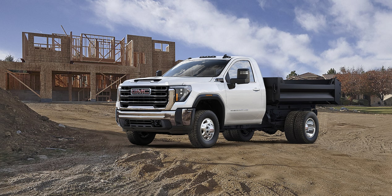 A GMC work truck parked near a job site.