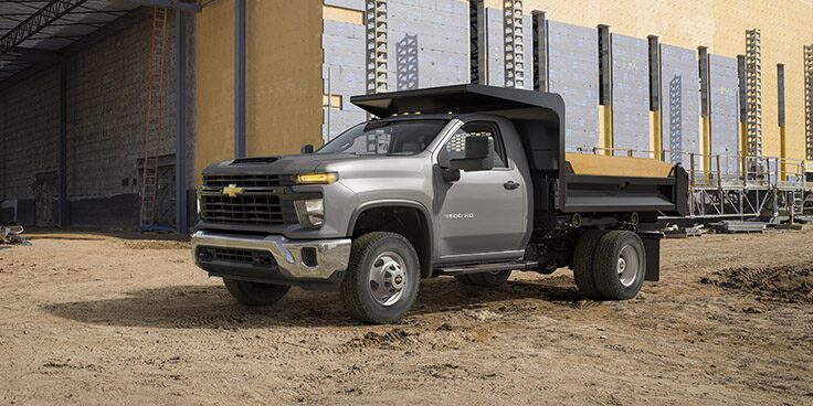 A Chevrolet work truck parked at a construction site.