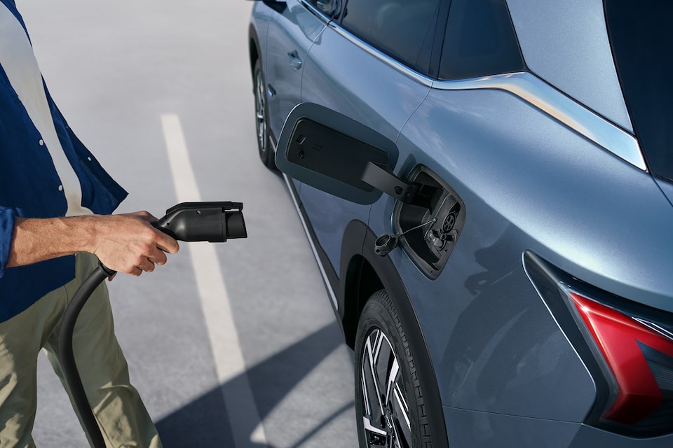 Man plugging in EV vehicle. 