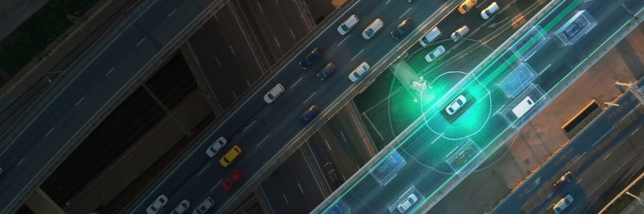 Overhead shot of a GM Envolve vehicle driving down a freeway with safety detection tracking.