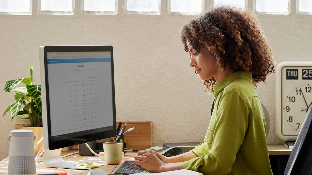 Side view of a person viewing OnStar-related information on a computer.