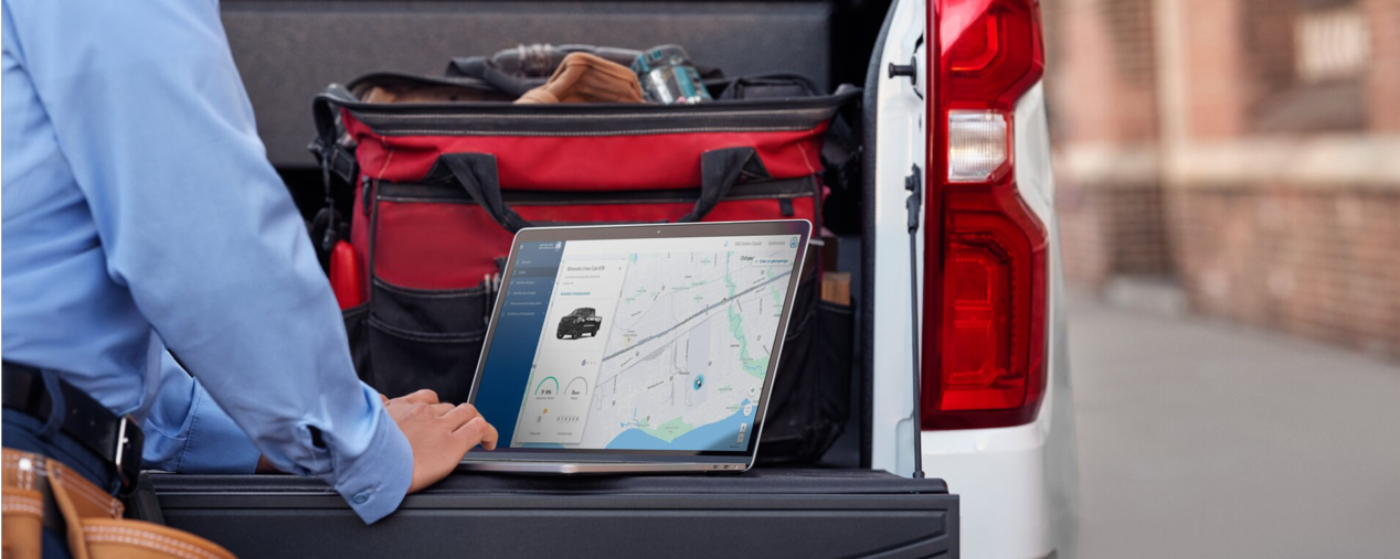 Une personne accédant à des informations en temps réel sur un véhicule GM Envolve depuis un ordinateur portable.