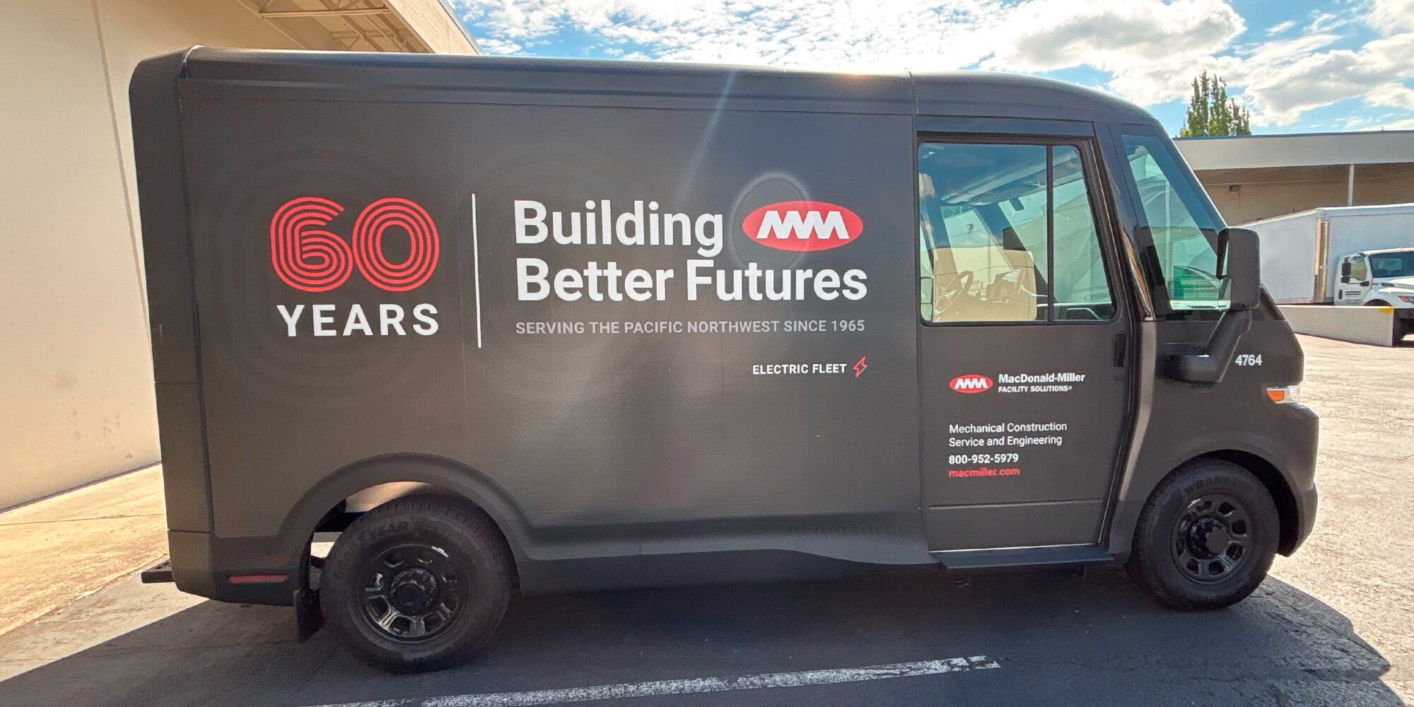 A Chevrolet Brightdrop with Macdonald Miller branding, in side profile