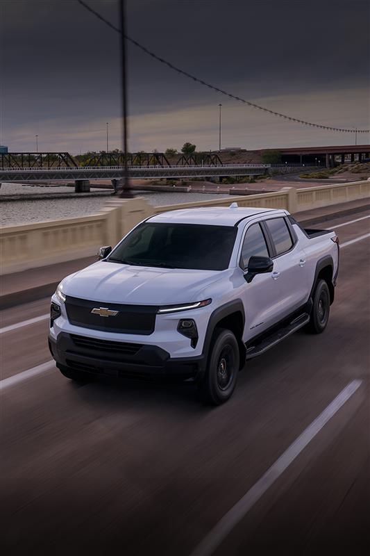 A 2025 Chevrolet Silverado EV driving down the road