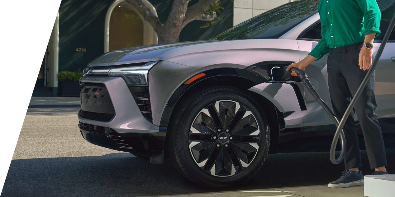 A driver charging a Chevy Blazer EV