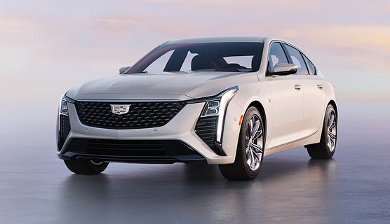 A white Cadillac CT4 parked in three-quarters view.