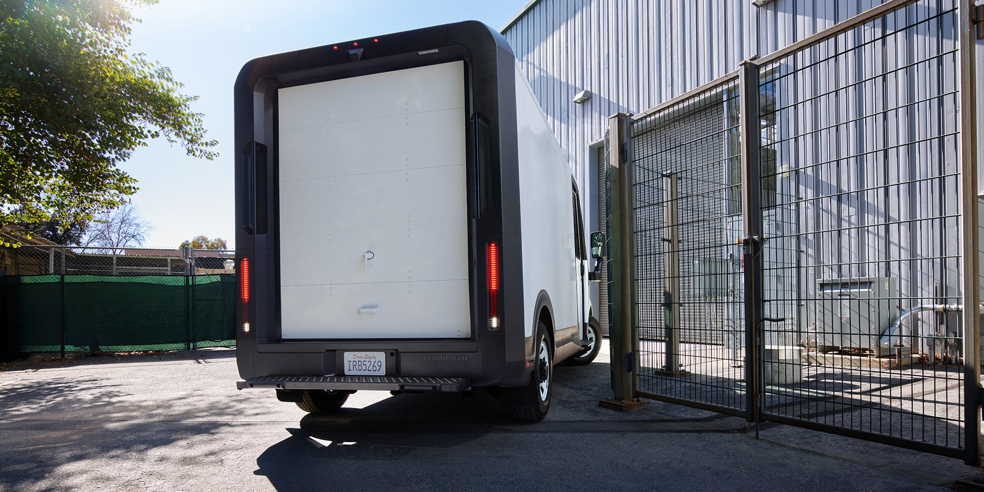 A BrightDrop Zevo driving through a residential area.