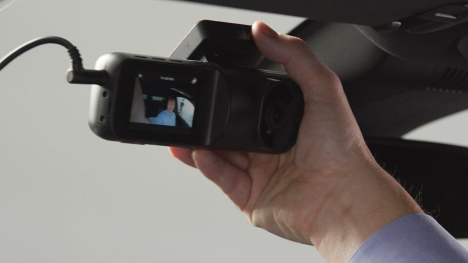 Image of OnStar DualCam being installed on interior windshield