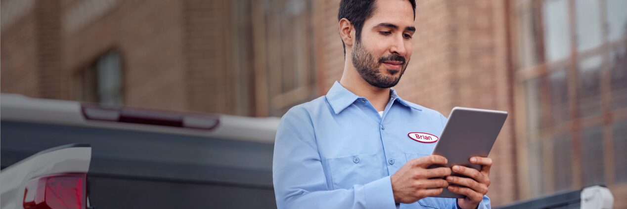 A man accessing OnStar Vehicle Insights from a tablet