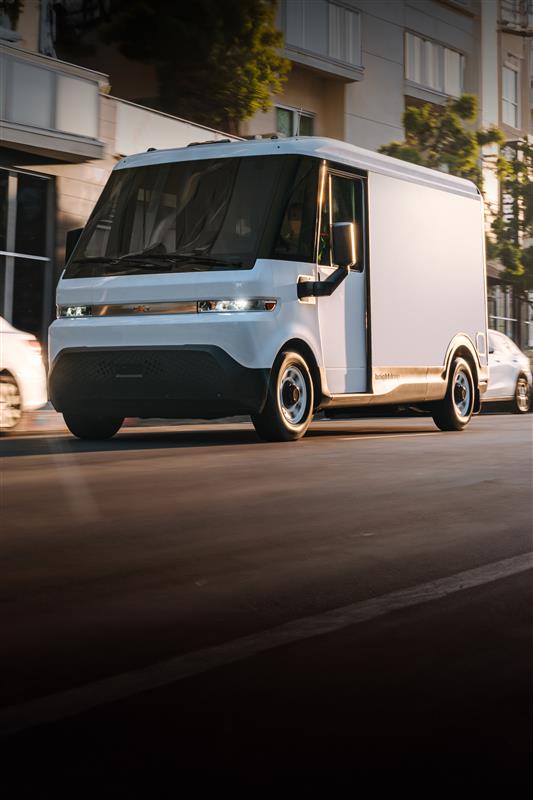 A white Chevrolet BrightDrop driving down a city street