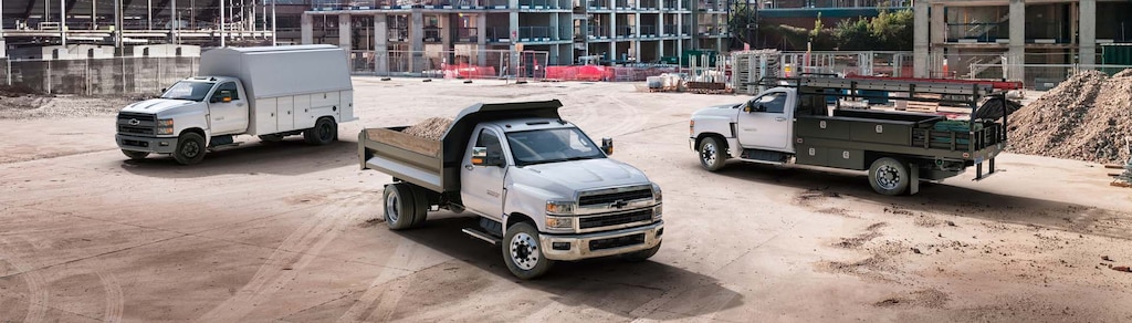 A Cargo Work Van, Brightdrop Vehicle and Heavy Duty Work Truck Side by Side