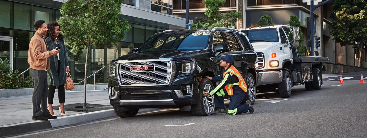 Roadside Assistance Worker Assisting Couple with Their Car
