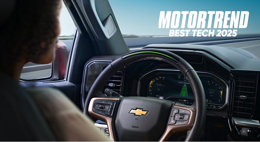 A woman sitting in the driver's seat of a Chevy with 'MOTORTREND BEST TECH 2025' overlay