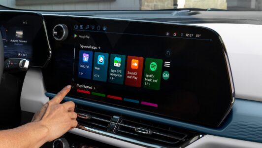 A person using the In-Vehicle Apps through the infotainment screen of an OnStar-subscribed GM vehicle.