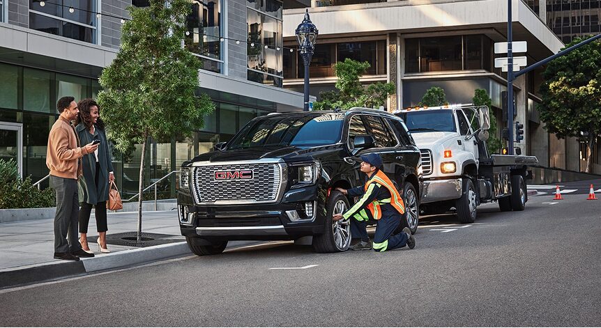 Roadside Assistance Worker Assisting Couple with Their Car