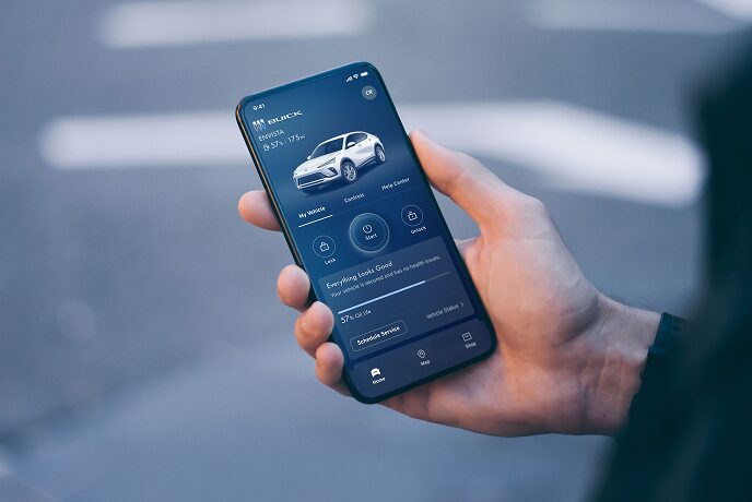 A person showing the stats of his vehicle presented on his smartphone app.