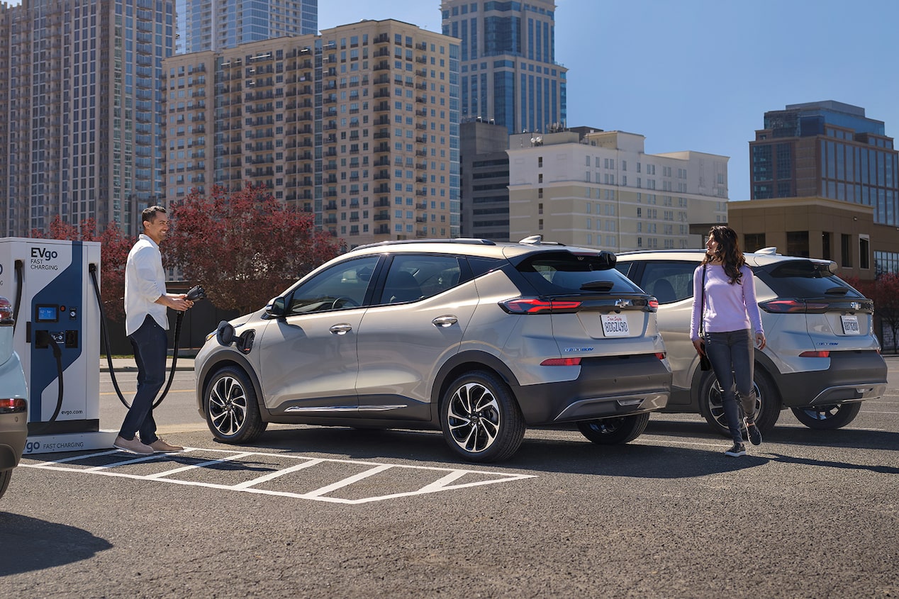 Group of People Checking out a Vehicle at an EV Charging Station