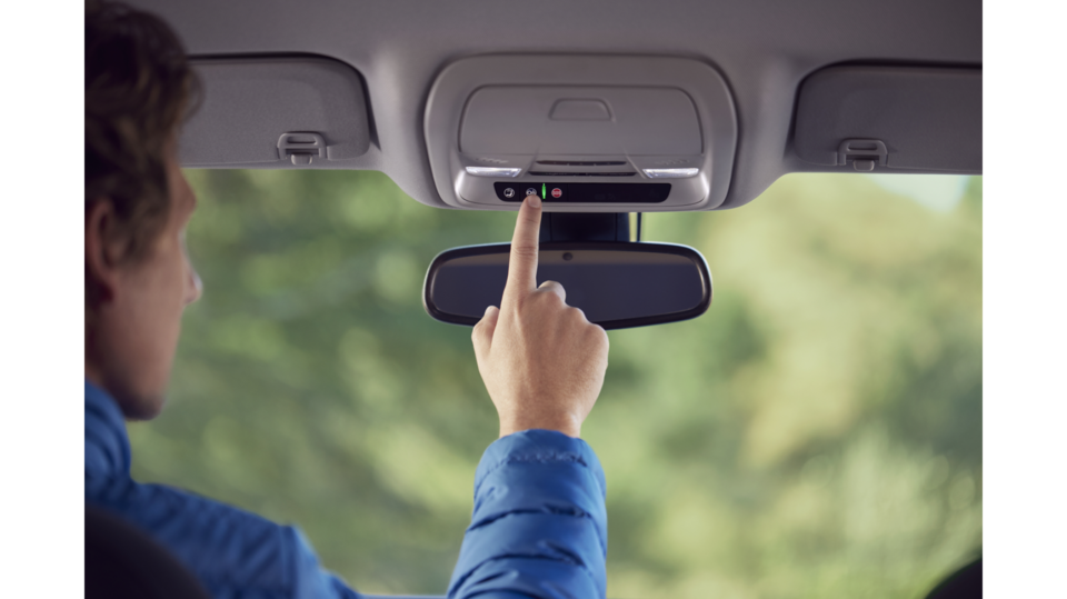 Driver Pressing the OnStar In-Vehicle App Button