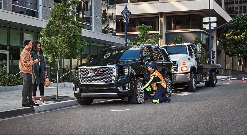 Roadside Assistance Worker Assisting Couple with Their Car